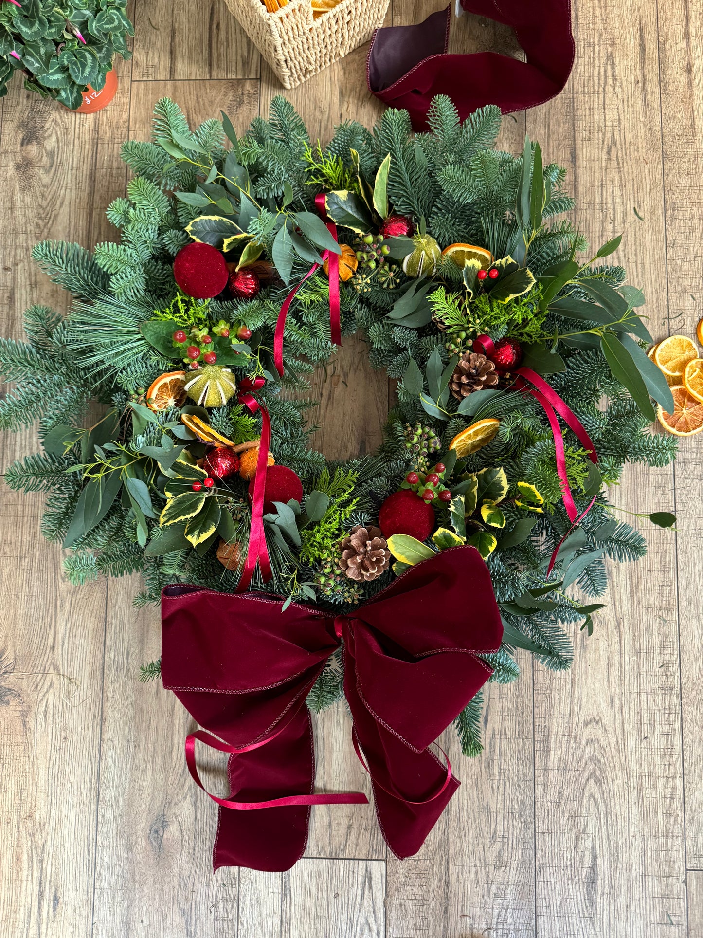 The Holiday Wreath styled on a front door  festive handmade design from Barns Florals