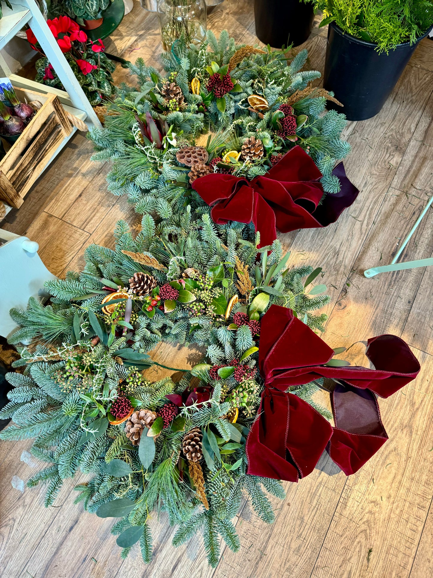 Textured Christmas wreath layered with fresh foliage, berries, and cinnamon sticks Barns Florals Cornwall.