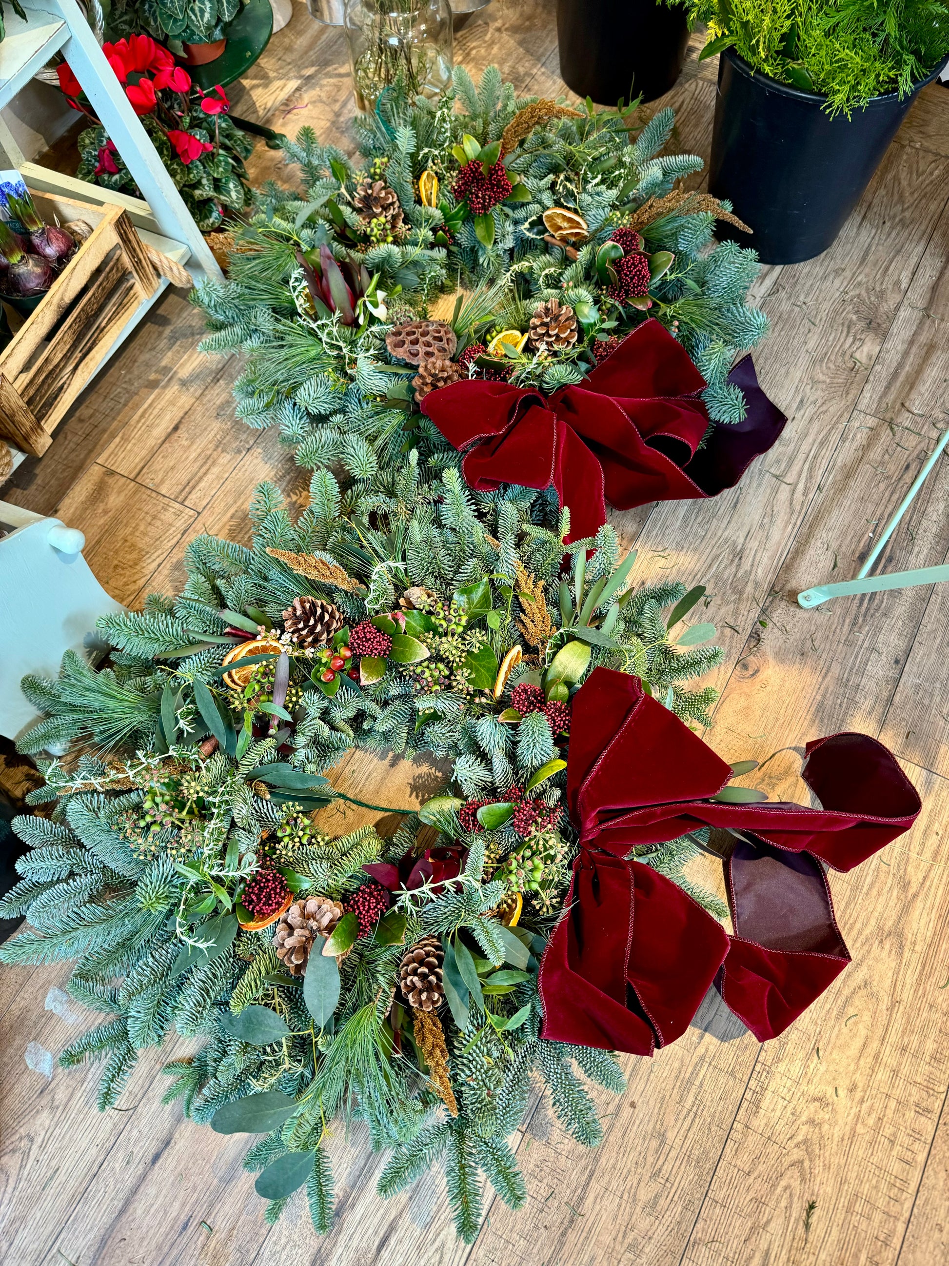 Textured Christmas wreath layered with fresh foliage, berries, and cinnamon sticks Barns Florals Cornwall.