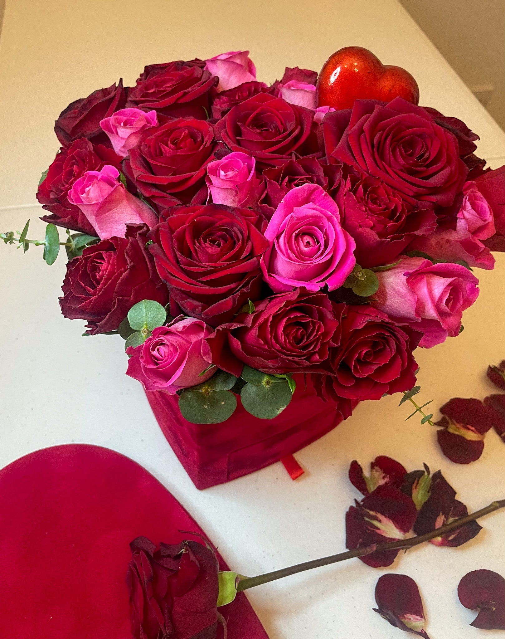 Luxurious pink and red roses in heart shaped box